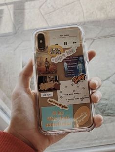 someone holding up their phone case with stickers on it