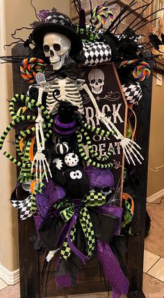 a halloween wreath with skeleton decorations on it