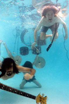 two people in the water with guitars and drums