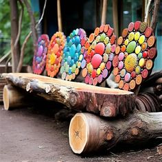 there are many different colored hearts on the logs in front of each other and one is made out of wood