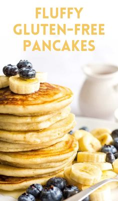 a stack of pancakes with blueberries and bananas on top