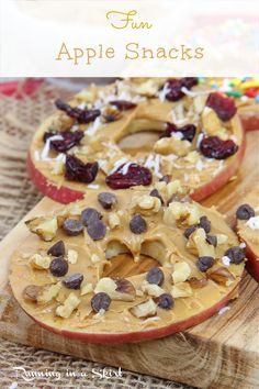 an apple snack with nuts and chocolate chips on top, sitting on a wooden cutting board