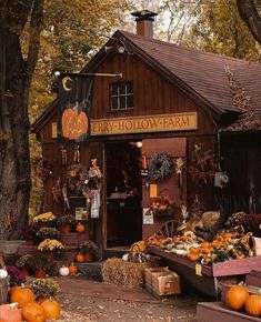 an outdoor store with pumpkins and other decorations on display in front of the building