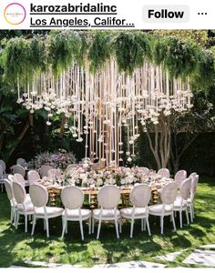 an image of a table set up with flowers and candles for a wedding reception in the garden