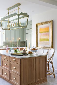 a kitchen with a large island in the middle and candles on it's counter