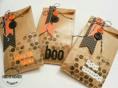 three brown bags with black and orange tags on them, one has a tag that says boo