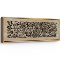 a wooden framed artwork with black and white letters on it