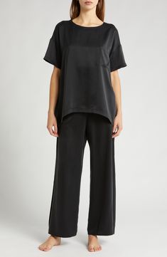 These mulberry-silk pajamas are naturally hypoallergenic, breathable and ideal for those with sensitive skin; best part—they can go in the washing machine. The elegant set pairs an oversized high-low T-shirt with flowy pants enhanced with split cuffs and side-seam pockets. Top has 28" front length, 30 1/2" back length; bottoms have 29" inseam, 25" leg opening, 12 1/2" front rise, 16 1/2" back rise (size Medium) Top has scoop neck; short sleeves; chest patch pocket; high/low hem Pants have back e Chic Silk Loungewear Sets, Relaxed Fit Satin Loungewear Sets, Elegant Silk Sleep Tops, Elegant Silk Nightwear Tops, Satin Loungewear Set With Relaxed Fit, Elegant Daywear Sets With Relaxed Fit, Elegant Relaxed Fit Daywear Sets, Elegant Relaxed Fit Sleepwear Long Pants, Elegant Satin Sleepwear With Short Sleeves