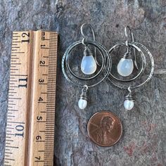 Two tiny genuine freshwater pearls are carefully wrapped in sterling silver wire. The white pearls dangle from sterling silver rings which I have formed, soldered, and hammered by hand. Inside the rings are natural Chalcedony teardrops. The earrings dangle from handformed Sterling Silver earwires. The silver has been oxidized and polished to create the patina finish. Be sure to see all photos and video for size and color reference. Total Earring Length: About 2 inches Silver Teardrop Hoop Earrings With Pearl Charm, Artisan Silver Jewelry With Pearl Drop, Adjustable Nickel-free Teardrop Pearl Earrings, Silver Teardrop Pearl Hoop Earrings, Sterling Silver Teardrop Dangle Earrings With Pearl Drop, Silver Teardrop Earrings With Pearl Charm As Gift, Sterling Silver Teardrop Pearl Drop Jewelry, Nickel-free Teardrop Pearl Earrings In Sterling Silver, Nickel-free Teardrop Pearl Earrings For Anniversary