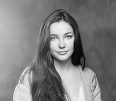 a black and white photo of a woman with long hair