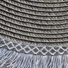 a close up view of a hat with fringes