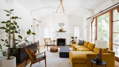 a living room filled with furniture and a fire place in the middle of a room