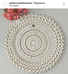 a crocheted doily is shown with flowers in the background and text that reads,