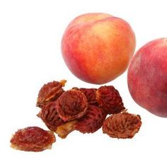 two peaches and one piece of fruit on a white background