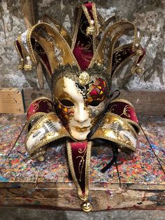 Original hand-painted Venetian mask embellished with gold leaf, decoration with stucco, acrylic colors and precious fabrics. -Material/Resin Made in Italy hypoallergenic and anatoxical -Dimensions/50x40Unisex -History of the mask / the Jester or joker is a mask that appears in Venice in 1970 year in which the Venetian Carnival returns to its former glory after being interrupted during the Napoleonic domination (1700') and Austro-Hungarian (1800'). Formerly a symbol of transgression and enjoyable