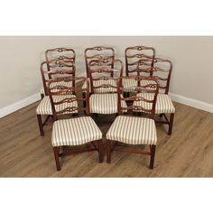 set of eight antique dining chairs with striped upholstered seat cushions, in good condition