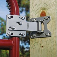 a close up of a metal latch on a red gate