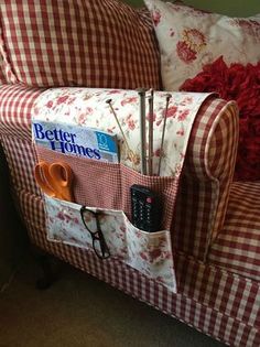 a red and white checkered couch with some scissors in the pocket on top of it