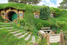 the hobbot house is surrounded by greenery and flowers