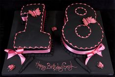 a black and pink birthday cake with the number twenty eight on it's side