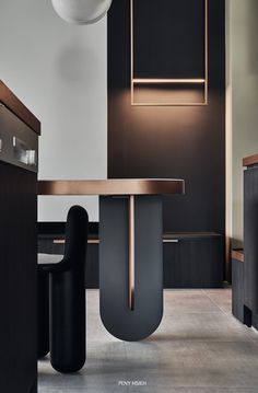 a modern dining room with black and gold accents on the walls, wood trim around the table