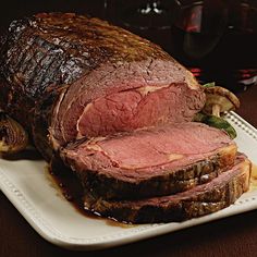 a large roast beef on a white platter