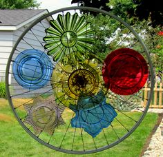 a wind chime hanging on the side of a house in front of a yard