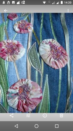 an applique on the back of a pair of jeans with flowers and leaves