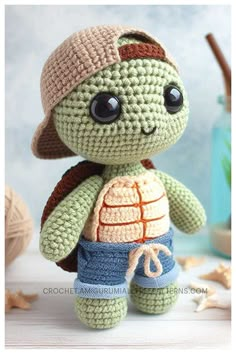 a crocheted turtle with a hat and shorts