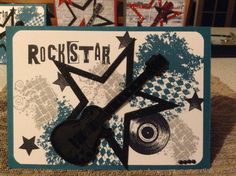 a rock star card with an acoustic guitar and stars on the front, sitting on top of a table