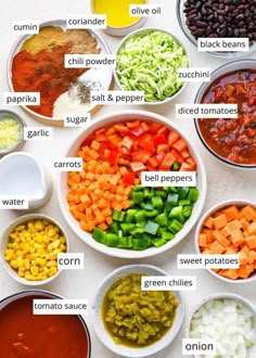 the ingredients to make mexican soup in bowls on a white counter top, including beans, carrots, bell peppers, corn, black beans and avocado