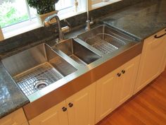 a stainless steel kitchen sink under a window