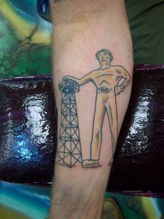 a man's leg with a drawing of an oil rig worker on the side