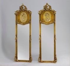 two golden mirrors sitting next to each other