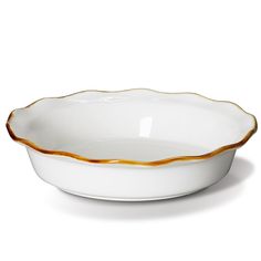 a white bowl with gold trimmings on the rim and bottom, sitting in front of a white background