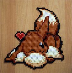 a cross stitch picture of a horse with a heart on it's back, laying down