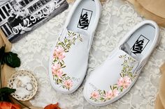 These White Slip On Vans have a soft flower design with gorgeous pink/peach flower arrangements and lush light green accents. These are the perfect and comfortable gift for wearing on the big day while also enjoying them after the fact while out for brunch and reminiscing on saying "I Do". These shoes are also perfect for your wedding party's flower girl, ring bearer, brides maids, etc. Add a custom date or initials! We buy each pair of shoes BRAND NEW. Each pair is made to order, please make su Painted Wedding Sneakers, Wedding Vans Shoes, Bridal Vans, Painted Wedding Shoes, Custom Slip On Vans, Shoes Artwork, Sneakers Wedding, Wedding Vans, Wedding Shoes Sneakers