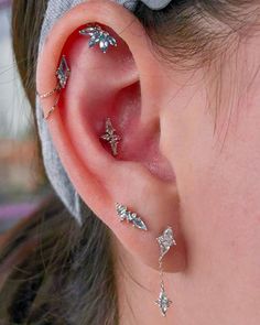 a woman with three different piercings on her ear