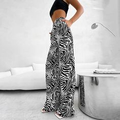 Make a statement with these zebra stripe wide-leg summer pants, the perfect addition to your casual wardrobe. Crafted from a soft and comfortable fabric with stretch, these pants feature a trendy street style design that is sure to turn heads. The elastic waistband ensures a comfortable fit, while the side stripe detail adds a touch of sporty chic. Whether you're running errands or grabbing lunch with friends, these pants are perfect for any casual occasion. Plus, they come in petite and short s Trendy Striped Wide Leg Pants, Trendy Striped Wide-leg Pants, Black Zebra Print Pants For Spring, Spring Black Zebra Print Pants, Black Zebra Print Bottoms For Spring, Trendy Striped Wide Leg Pants For Spring, Casual Black Zebra Print Pants, High Waist Zebra Print Bottoms For Spring, Spring Wide Leg Zebra Print Pants