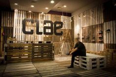 a man sitting on top of a wooden bench in front of a sign that reads cb9