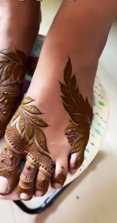 the feet are decorated with henna and leaves