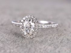 an oval cut diamond ring with pave set shoulders