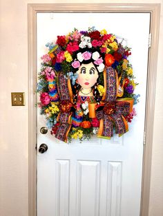 a fridace decorated with flowers is on the door to a room that has a white door