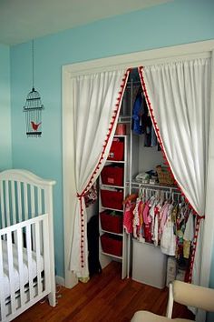 a baby's room with blue walls and white furniture