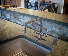 a kitchen counter with a sink and faucet