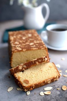 two slices of cake sitting on top of a table next to a cup of coffee