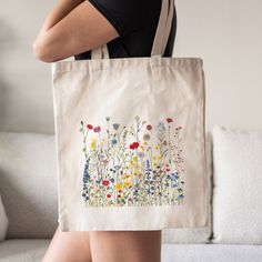 This wildflower tote bag is a stylish upgrade to reusable tote bags. This floral canvas tote bag make a great reusable tote for yourself or as a gift tote for plant lovers. ⚡ USA Fast Delivery. We Deliver Within A Week. ⚡ Our Tote Bags are made with 100% cotton sheeting. Add their reinforced handle stitching to the mix, and you got a reliable bag rich in both practicality and durability. These durable totes are crafted with a last technological DTG printer for a vibrant flawless finish. Tote bag Eco-friendly Floral Canvas Bag For Everyday Use, Eco-friendly Everyday Bags With Floral Print, Spring Gift Reusable Bag, Spring Gift Bag Reusable, Botanical Flower-shaped Bag For Daily Use, Botanical Flower-shaped Bags For Daily Use, Botanical Flower Shaped Bags For Daily Use, Eco-friendly Flower-shaped Bags For Spring, Spring Reusable Bags