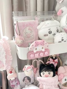 a shelf filled with lots of stuffed animals and other stuff items in front of a window