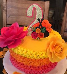 a birthday cake decorated with flowers and the number two