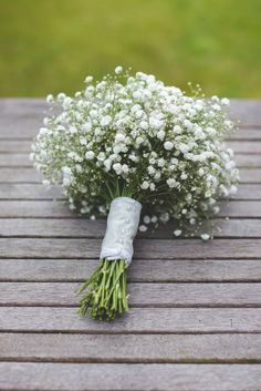 a bouquet of baby's breath on a wooden table